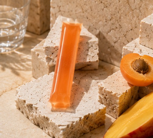 Move jelly stick on wet travertine with halved white peach