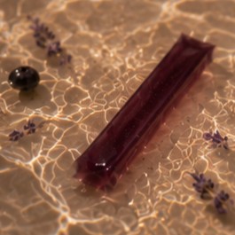 Rest jelly stick in water with blackcurrants and lavender sprigs